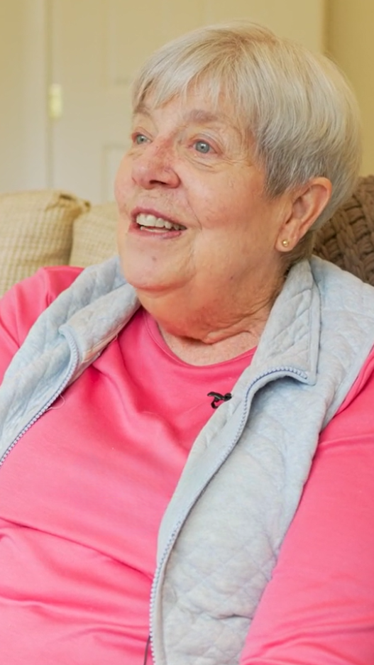 Senior woman in pink shirt with grey sweater vest